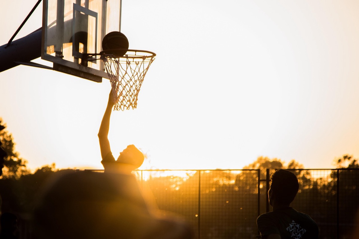 Professional basketball gear including high-top sneakers and a basketball