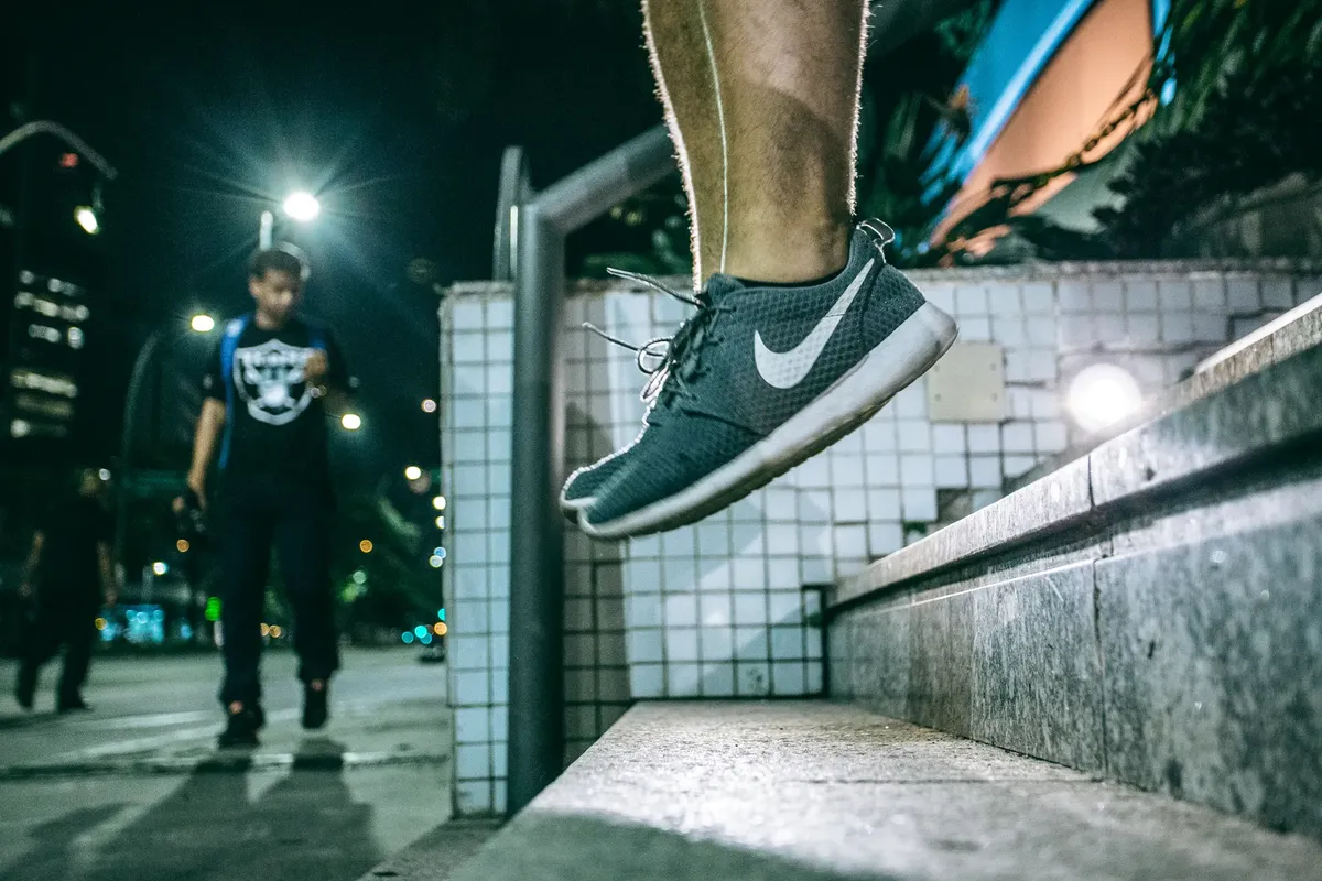 Captivating urban night scene with a person jumping, showcasing active lifestyle and movement.