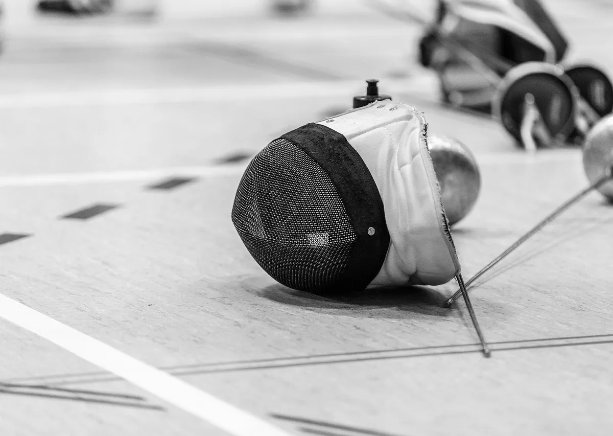 Fencer's hand moving toward opponent's chest