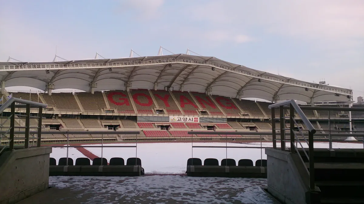 Scenic view of Goyang Stadium in winter, with snow covering the seats and field.